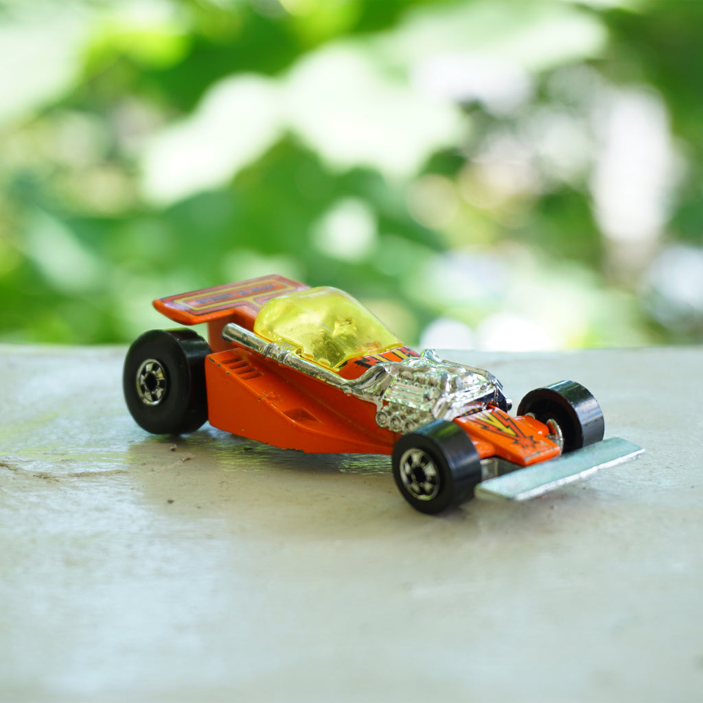 1981 Vintage Diecast HOT WHEELS Land Lord Orange Race Car. Made by Mattel, Inc.