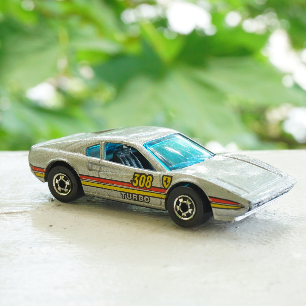 1982 Vintage HOT WHEELS Ferrari Racebait 308 Turbo SIlver Car with Red and Yellow Detail. Made by Mattel, Inc.