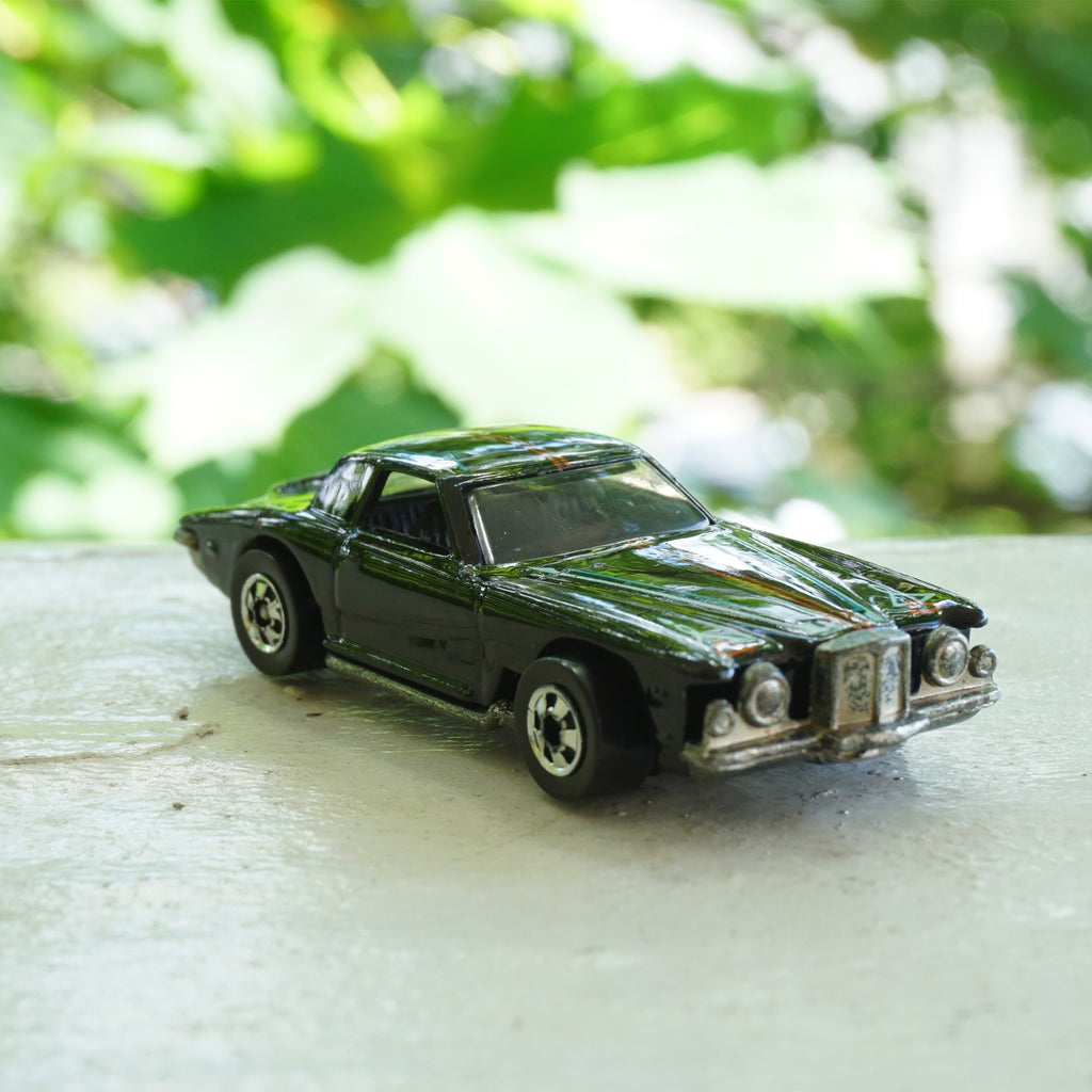 1979 Vintage HOT WHEELS Stutz Blackhawk Black Car with Red & Blue Line Detail. Made by Mattel, Inc in Malaysia.