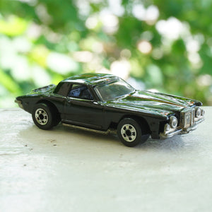 1979 Vintage HOT WHEELS Stutz Blackhawk Black Car with Red & Blue Line Detail. Made by Mattel, Inc in Malaysia.