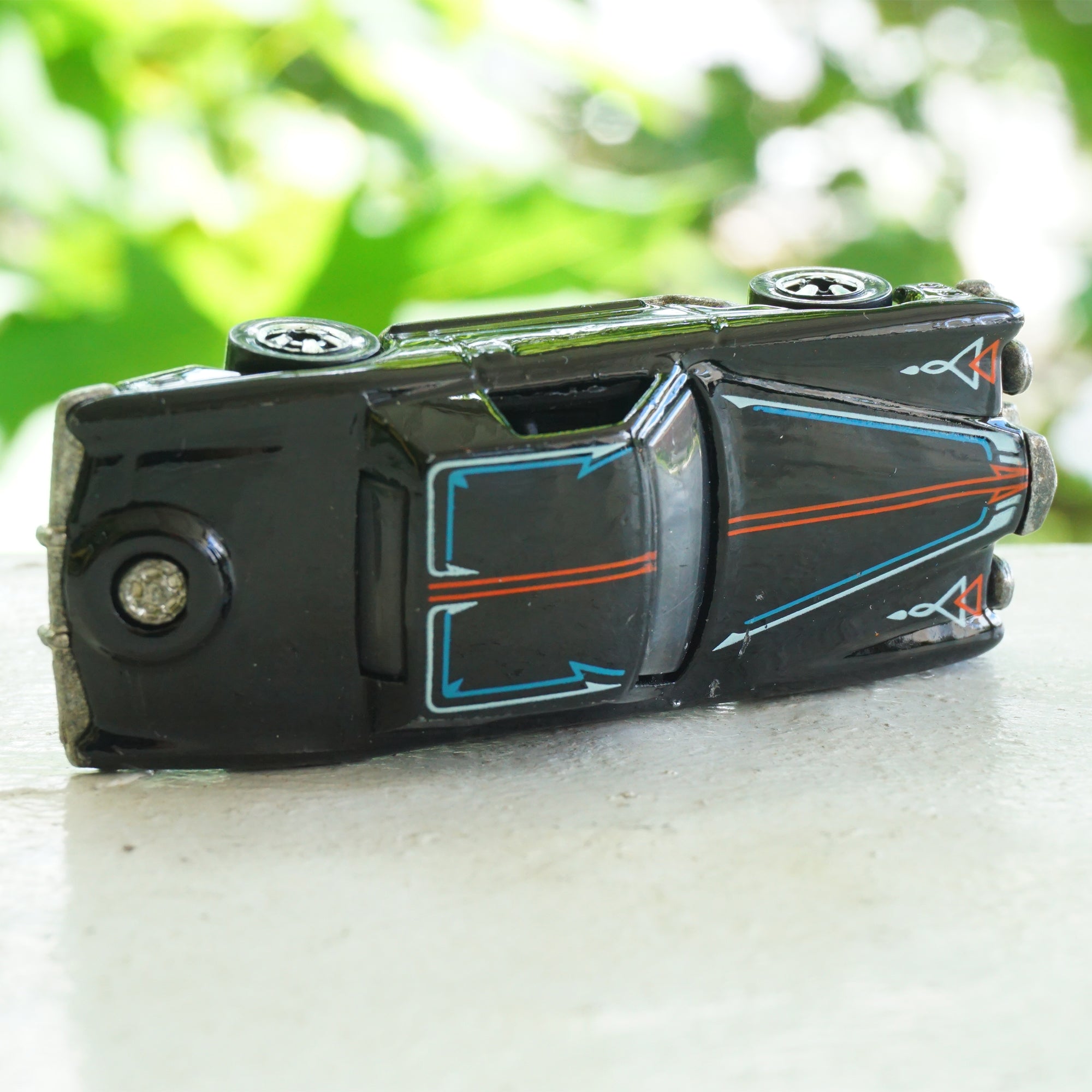 1979 Vintage HOT WHEELS Stutz Blackhawk Black Car with Red & Blue Line Detail. Made by Mattel, Inc in Malaysia.