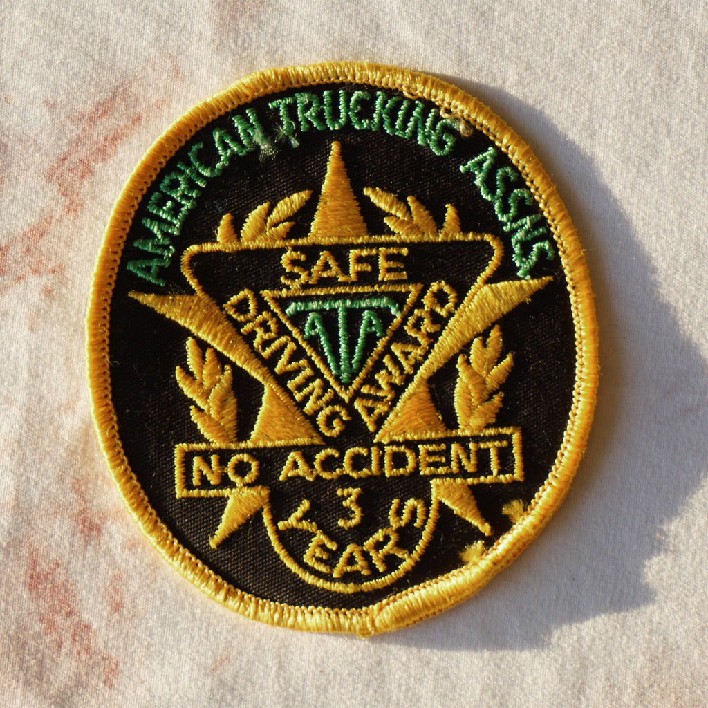 1980s Vintage 3" AMERICAN TRUCKING ASSNS Safe Driving Award Clothing Patch. No Accidents 3 Years. Gold, Black and Green Colors.