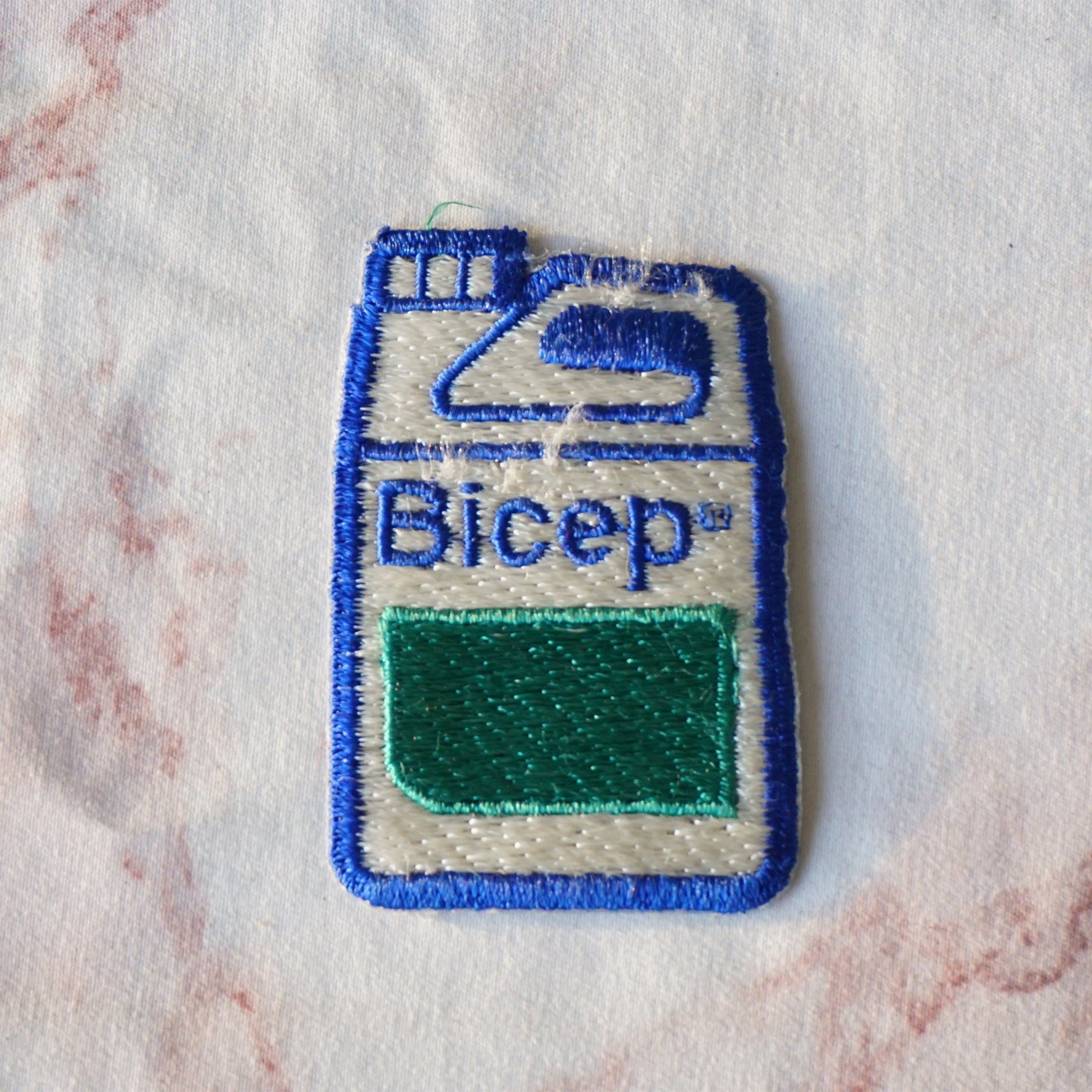 1980s Vintage 2" BICEP Canister Clothing Patch. Blue, Green and White Colors.
