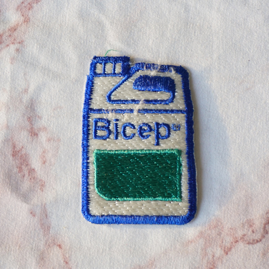 1980s Vintage 2" BICEP Canister Clothing Patch. Blue, Green and White Colors.
