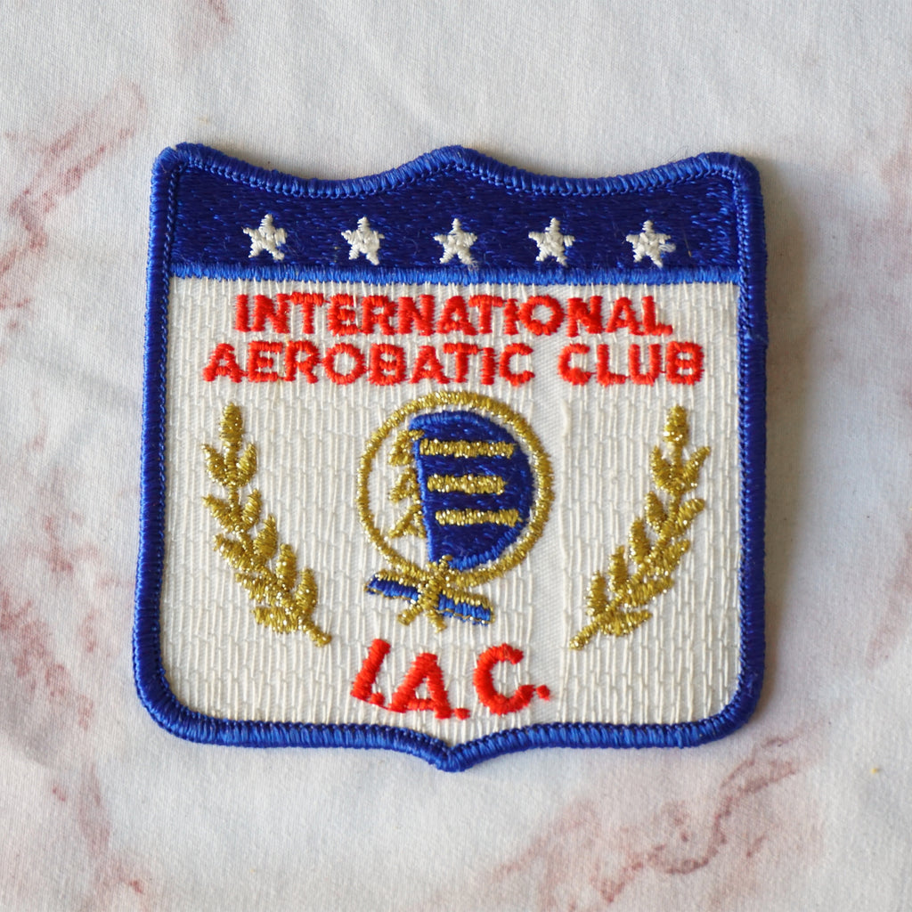 1980s Vintage 3.75" International Aerobatic Club I.A.C. Clothing Patch. Blue, Red, Metallic Gold and White Colors.