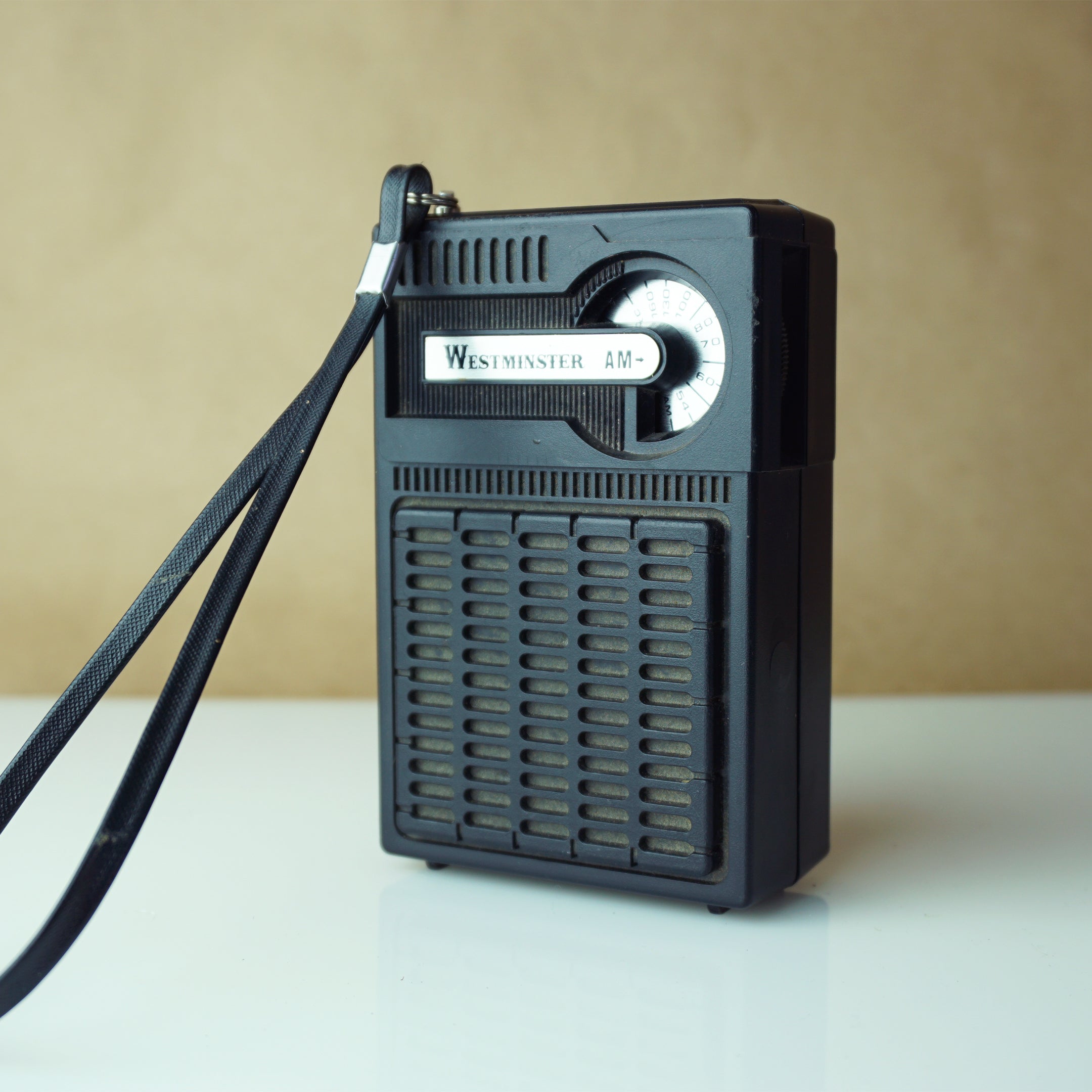 Radio FM/LW. A picture taken in the 1950s- 1960s of a portable transistor  radio. On the front of it a scale with knobs to turn to listen to radio  stations transmitting on